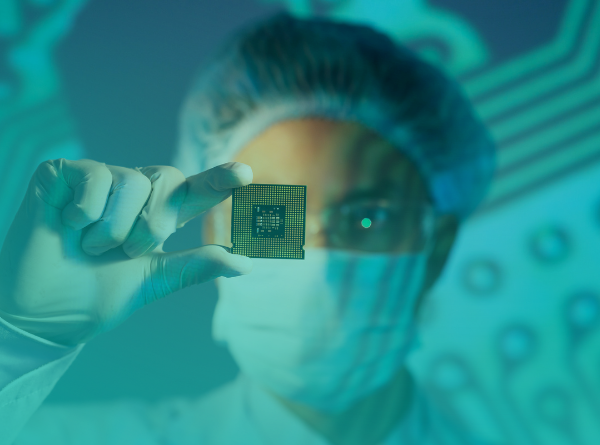 Worker looking at semiconductor chip